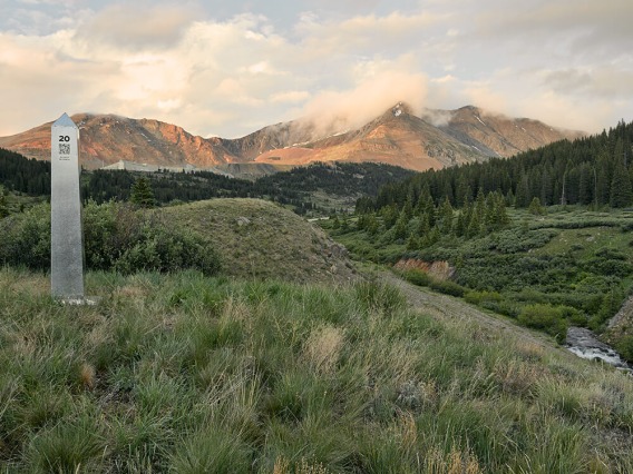 Cover Volume 21, photo of landscape of grassy hills with mountains in the background