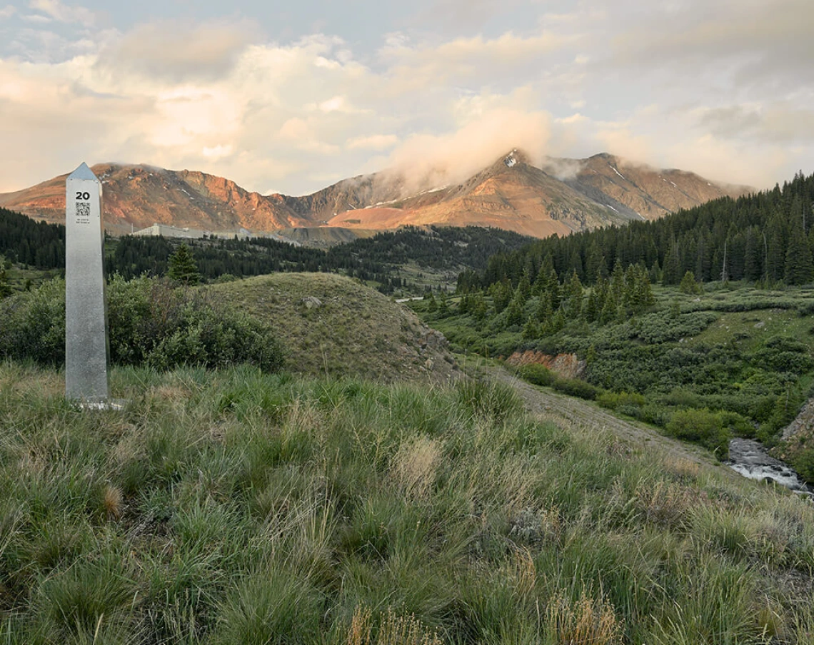 Cover Volume 21, photo of landscape of grassy hills with mountains in the background